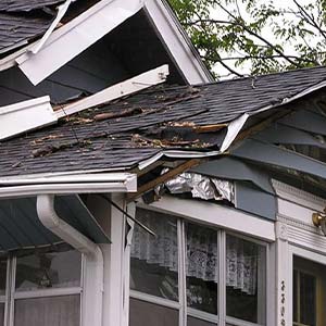 House with Storm Damage to Roof and Siding